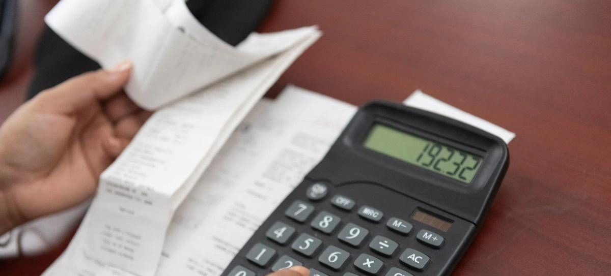 Reviewing receipts with a calculator at ALOE Accounting and Tax